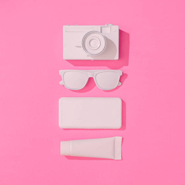 Creative neatly arranged layout with various summer objects on pastel pink background,  Minimal vacation concept 
