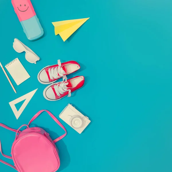 Creative layout of school supplies against pastel blue background. Minimal back to school concept