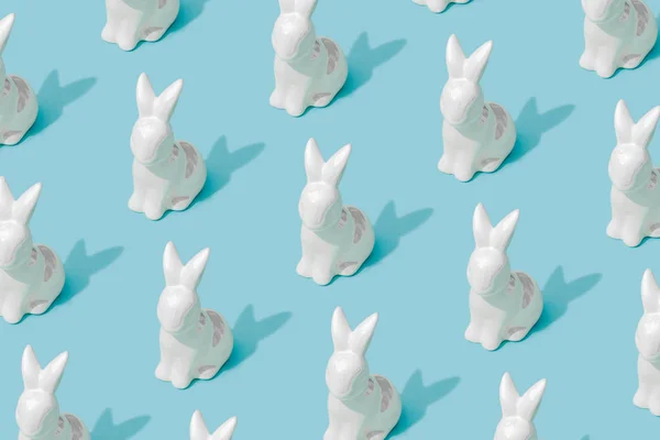 Pattern composition of Easter bunnies on pastel blue background. Minimalist isometric concept.