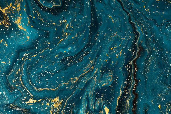 Abstract blue paint background with golden glitter powder 
