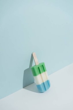 Pastel mavi arka plan üzerinde renkli Dondurma popsicle. Minimal yaz konsepti 
