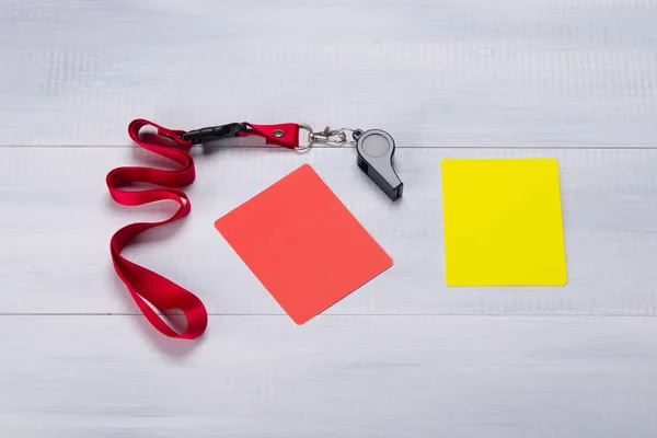 two penalty cards and a whistle for the judge, on a gray background