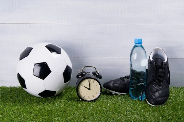 Soccer Ball Bottle Water Black Boots Alarm Clock Stand Grass — Stock Photo, Image