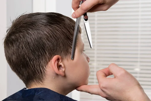 Handen Van Kapper Houdt Het Hoofd Van Jongen Correct Kam — Stockfoto