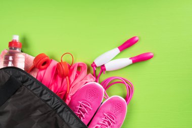 kırmızı bir spor çantası yeşil bir arka plan bir yazıt için boş alan köşesinde şeylerle Kulaklığımda