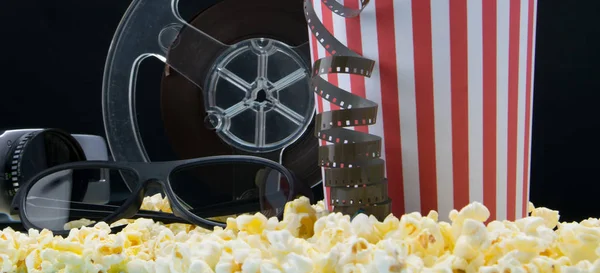 on the popcorn are 3 d glasses, video camera and film