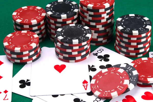 poker cards as a background, on a green table, surrounded by chips