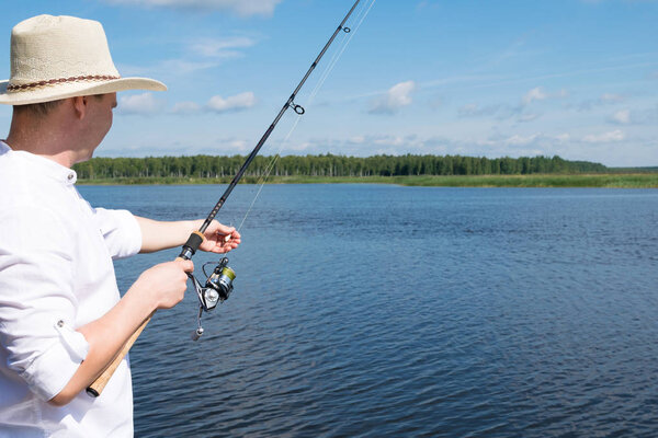 fishing in the summer in sunny weather on a beautiful lake