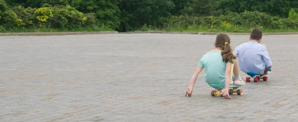 Parque Aire Libre Niño Una Niña Montando Monopatín Sentado Pavimento — Foto de Stock