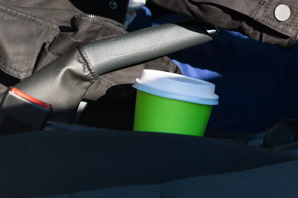a glass of hot drink stands in the car stand, close-up
