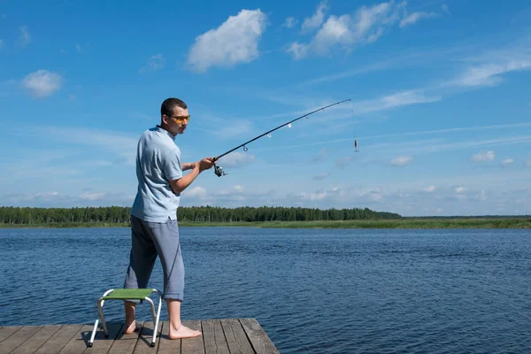 Man Sunglasses Throws Bait Spinning Lake Fishing — Stock Photo, Image