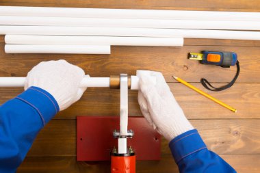 beyaz eldiven işçilerin eller, ahşap bir arka plan üzerinde, ısınma sürecinde kaplin ve boru düzeltmek