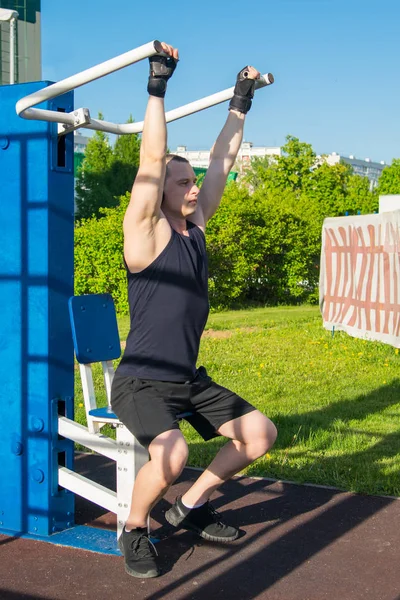 man exercising on a street simulator to strengthen the back