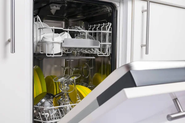 open dishwasher door with clean dishes inside