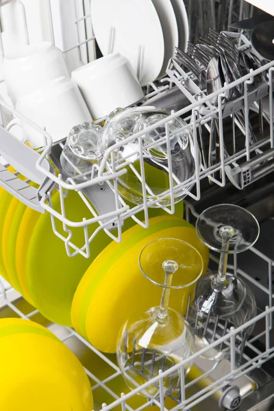 two loading nets with clean plates, cups and glasses, after washing in an economical dishwasher