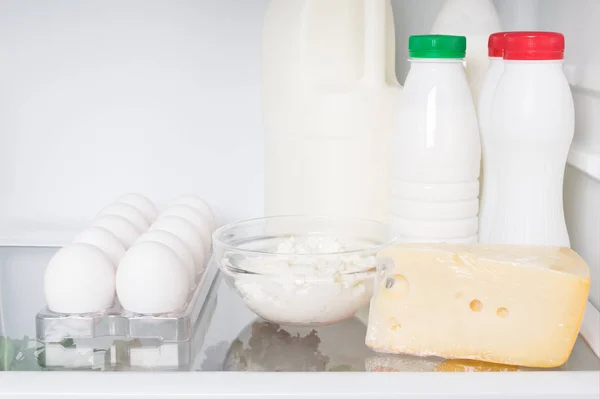 farm dairy products and eggs on a shelf in the refrigerator