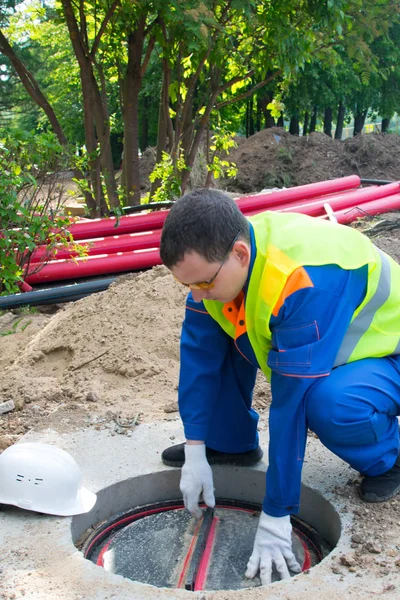 Robotnik Niebieskim Mundurze Zamyka Pokrywę Kolektora Komunikacji — Zdjęcie stockowe