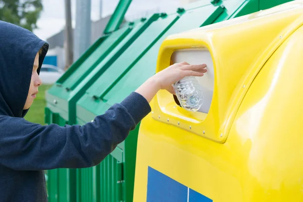 Boy Blue Sweater Hood Throws Empty Bottle Trash Can — Stock Photo, Image