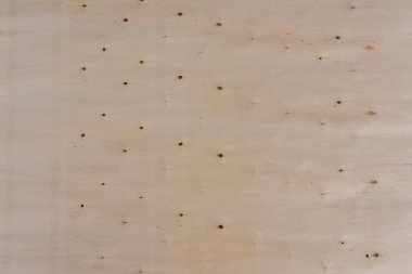 Açık ahşap bir yüzeye yakın çekim. Dokuda doğal tahıl, düğüm ve çatlaklar var. Arkaplan, tasarım veya materyal referansı için ideal.