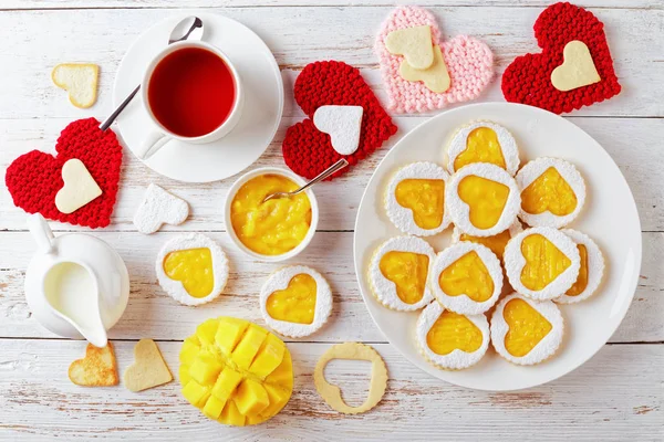 Heart Shaped Linzer Cookies Filled Mango Jam White Plate Wooden — Stock Photo, Image