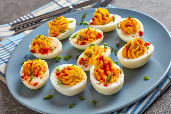 Deviled Eggs Sprinkled Paprika Finely Chopped Green Onion Grey Plate — Stock fotografie