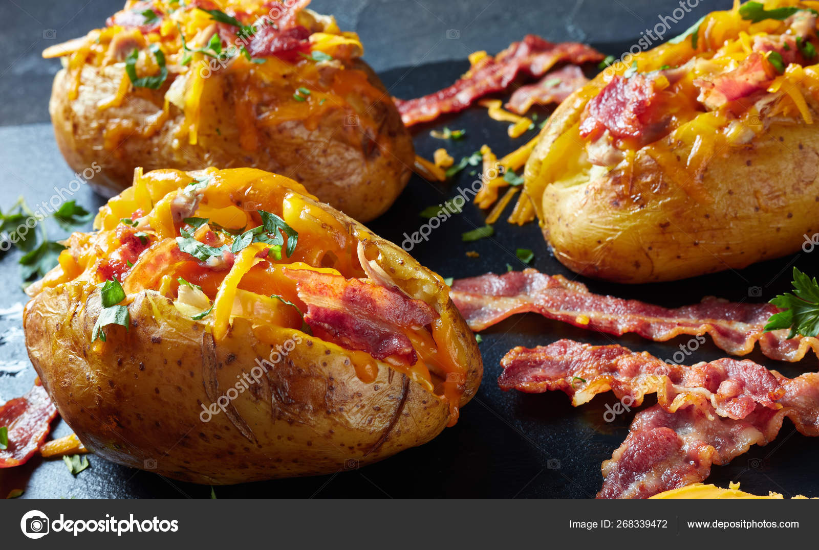 Loaded Baked Potatoes with Bacon, cheese, meat Stock Photo by