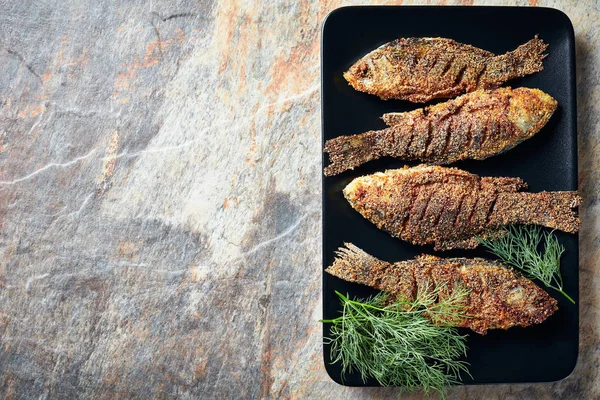 Fried crispy crucian carps on a plate — Stock Image Fried crispy crucian carps on a plate Royalty Free Stock Photos