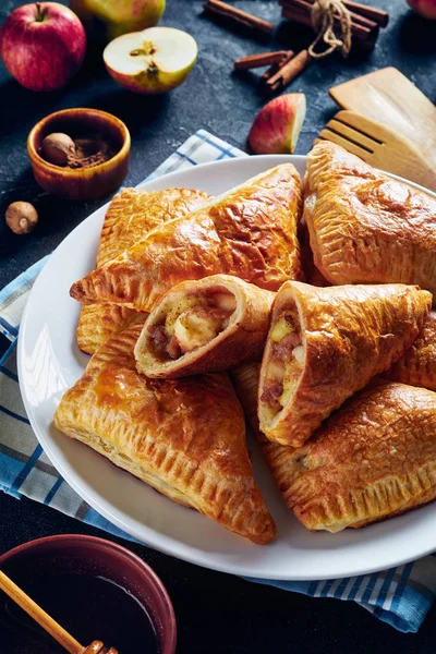 Apple turnover on a white plate, vertical view — Stock Photo, Image