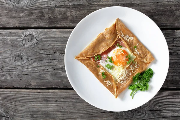 Crêpe bretonne avec oeuf sur une assiette blanche — Photo