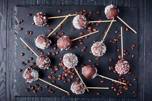 Chocolate cake pops on a black tray — Stock Photo, Image