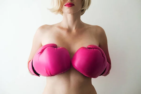 Naked woman with pink boxing gloves. Sexy and strong. Feminism, girl power, fight, gender, woman rights concept