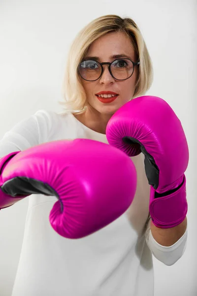 young woman with pink boxing gloves. Girl in red dress are fighting, attacking and protecting.  Feminism, girl power, fight like girl, gender, woman rights concept