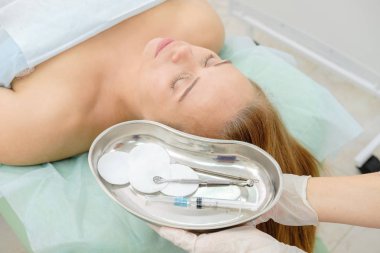 Mezoterapi ve botox enjeksiyon yapma güzellik uzmanı. Steril enjektör ile hasta ve tıbbi tepsi. Şevval Özçelik Güzellik tedavi kadın. Kozmetik, yüz gençleştirme, güzellik salonları, plastik cerrahi Kliniği