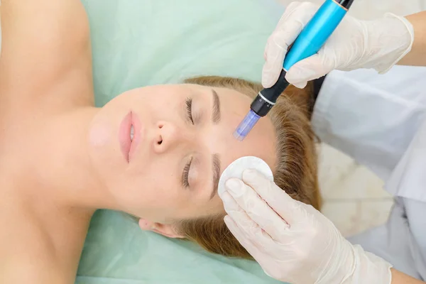 Cosmetologist making mesotherapy injection. Microneedle mesotherapy. Treatment woman at beautician. Hardware cosmetology. Mesotherapy, dermapen, treatment of face zone, face rejuvenation.  Close up