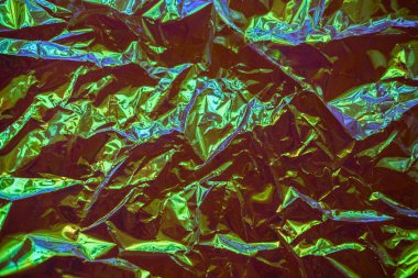 Holografik gerçek dokusu kıvrımları ve usulsüzlükler ile yanardöner mavi yeşil renklerde. Holografik renkli folyo buruşuk. Buruşuk soyut doku arka plan