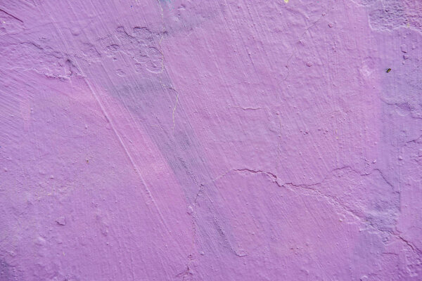 Purple paint on old wall. Surface texture detail with peeling old paint. Background. Close up