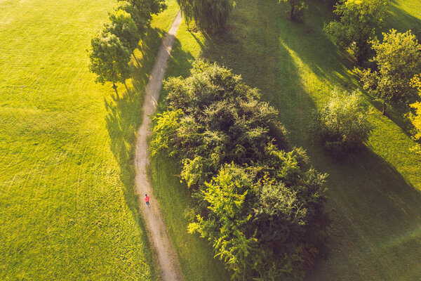 Drone aerial view of woman running in Nemunas Island park. Kaunas is the second-largest city in country and has historically been a leading centre of economic, academic, and cultural life