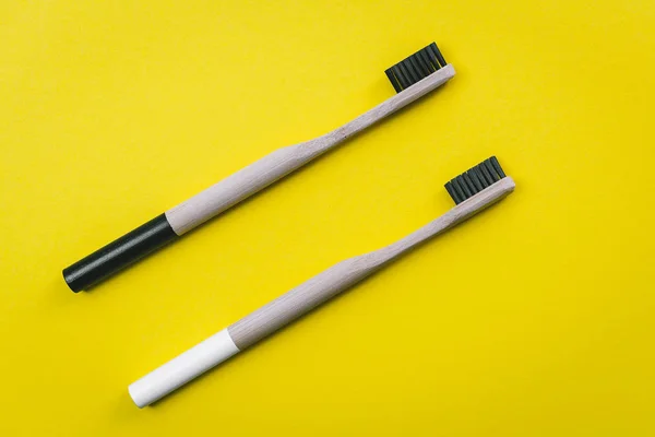 Two Bamboo Toothbrushes Isolated Yellow Background — Stock Photo, Image