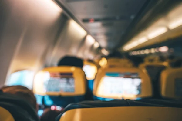 Blurred image of airplane interior in cabin