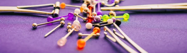 Body piercing jewelry rings, puncturing implants on colorful background