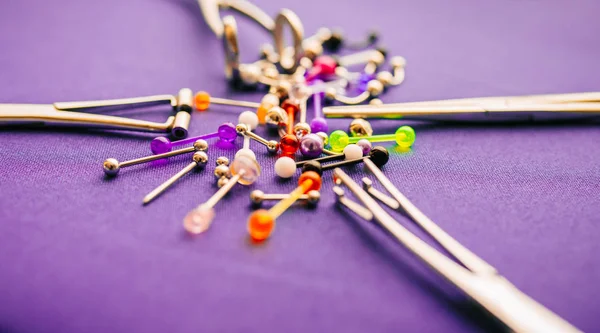 Body piercing jewelry rings, puncturing implants on colorful background