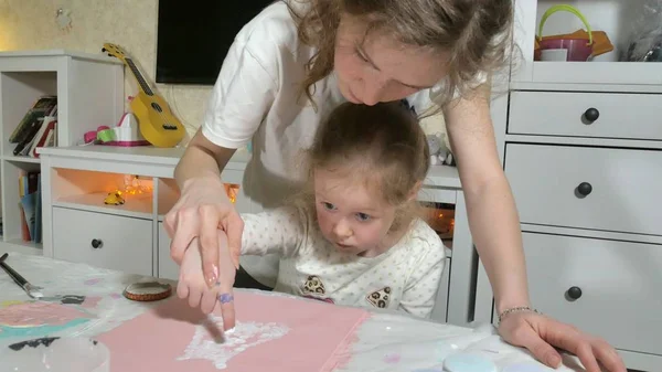 Anya és gyermeke festeni, színes ujjaival. Játékok a gyerekek befolyásolja a gyermekek korai fejlesztése. — Stock Fotó