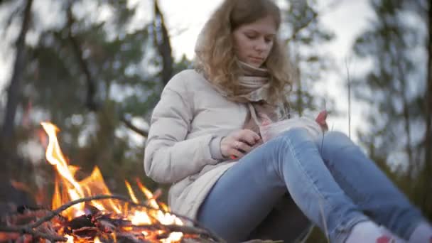 Lycklig familj av turister på en resa. Mamma och barn stek korv på elden nära tältet — Stockvideo