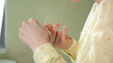 Kendiniz evde masada bir Manikür yapıyor kadın.