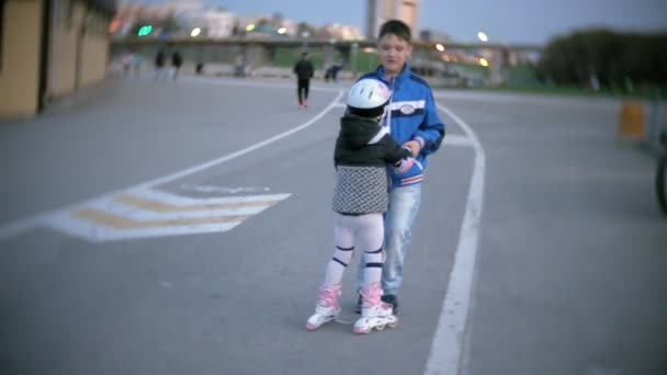 Liten flicka klänningar lära sig att åka skridskor. Koncept: sport, livsstil, hälsa. — Stockvideo