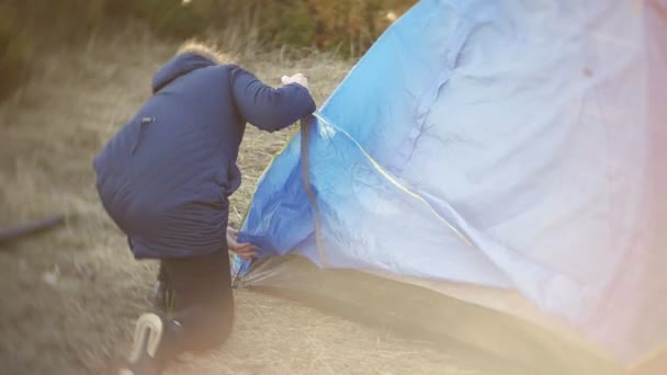 Gyermekek gyűjteni egy turisztikai sátor a természet az erdő — Stock videók