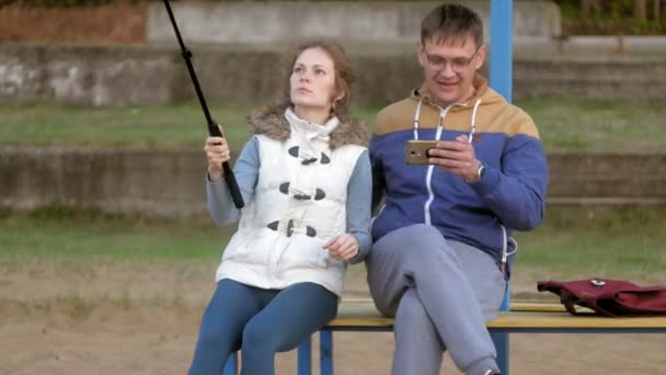 Muž fnd žena úsměv si vlastní obrázek selfie s chytrý telefon mobilní na park — Stock video