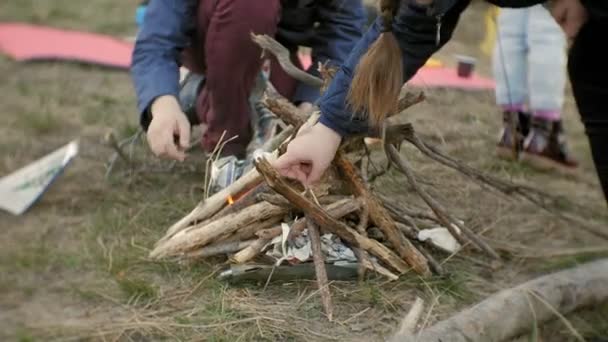 Happy family of tourists on a journey. Mom and children raise a fire — Stock Video