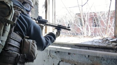 Kamuflaj tüfek Dürbünü pencereden bir eski bina, askeri kavram üzerinden amaçlayan bir askeri silah ile askerler