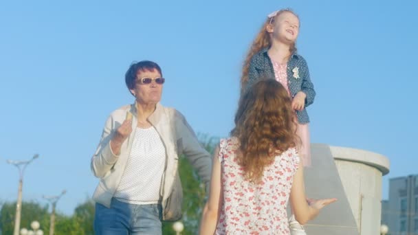 Mother and daughter are walking in the sunny city — Stock Video